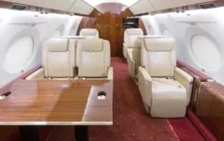 A seating area with multiple seats and a table inside the aircraft.