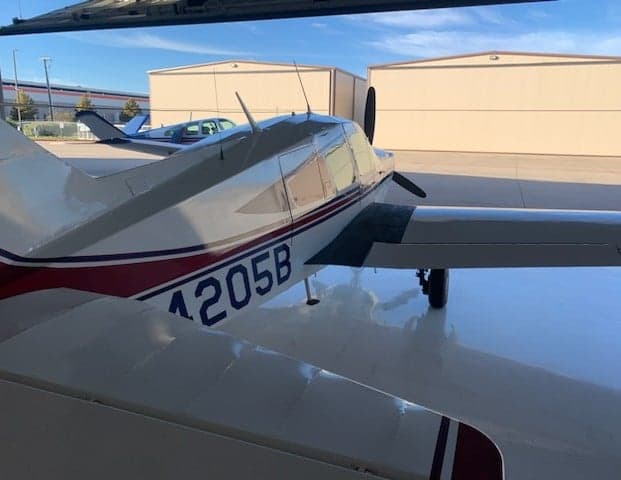 Close-up side view of N4205B aircraft tail in a hangar.