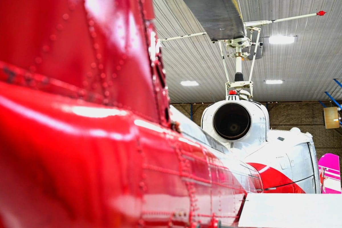 Close-up of the tail section and rotor assembly of the N857SD helicopter.