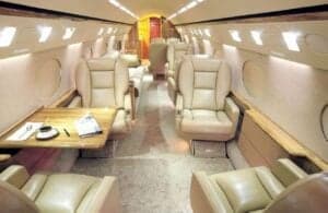 The interior of the aircraft features leather seats and a table.