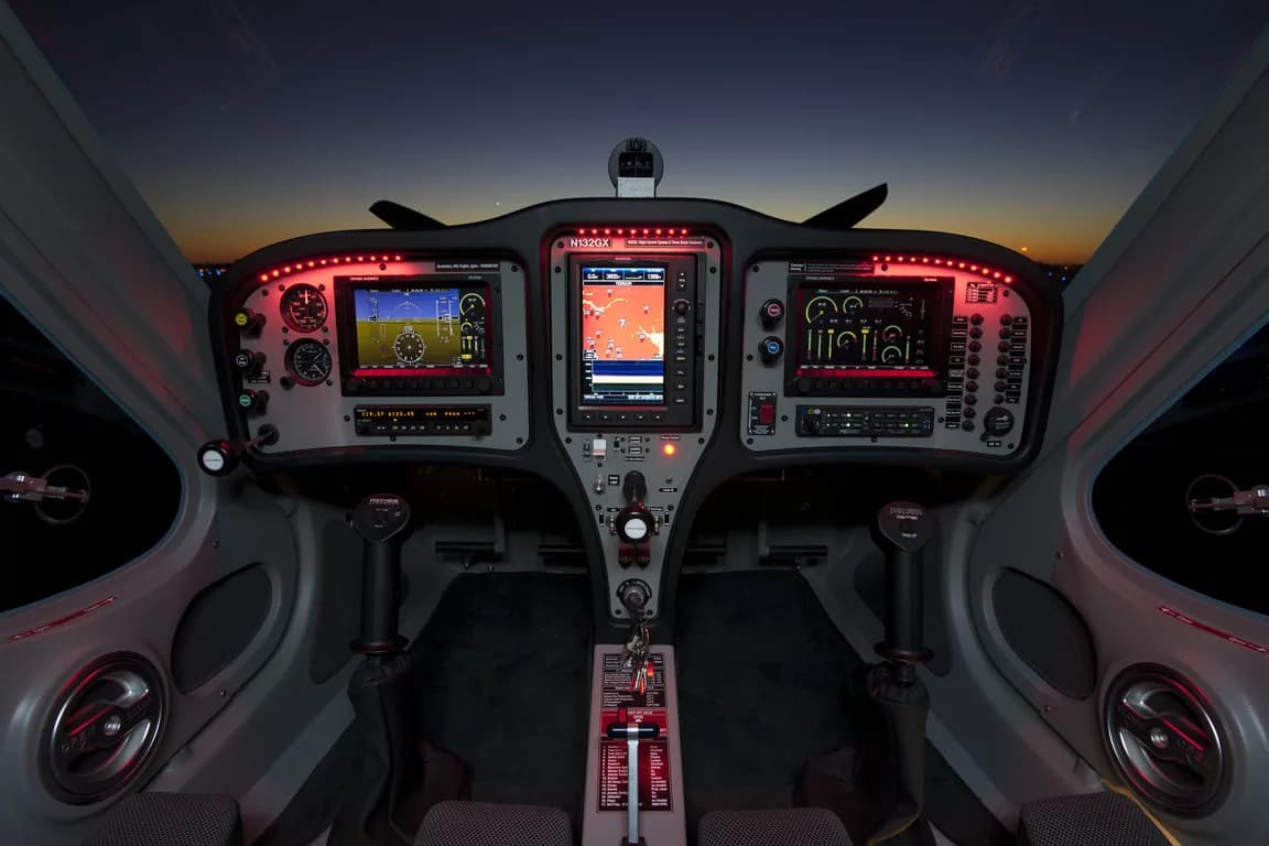 Cockpit view of the REMOS GX instrument panel at dusk.