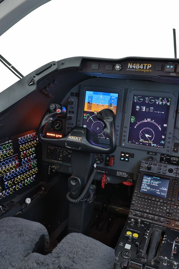 Close-up of the Hawker 400XP cockpit showing the control yoke and instrument panel.