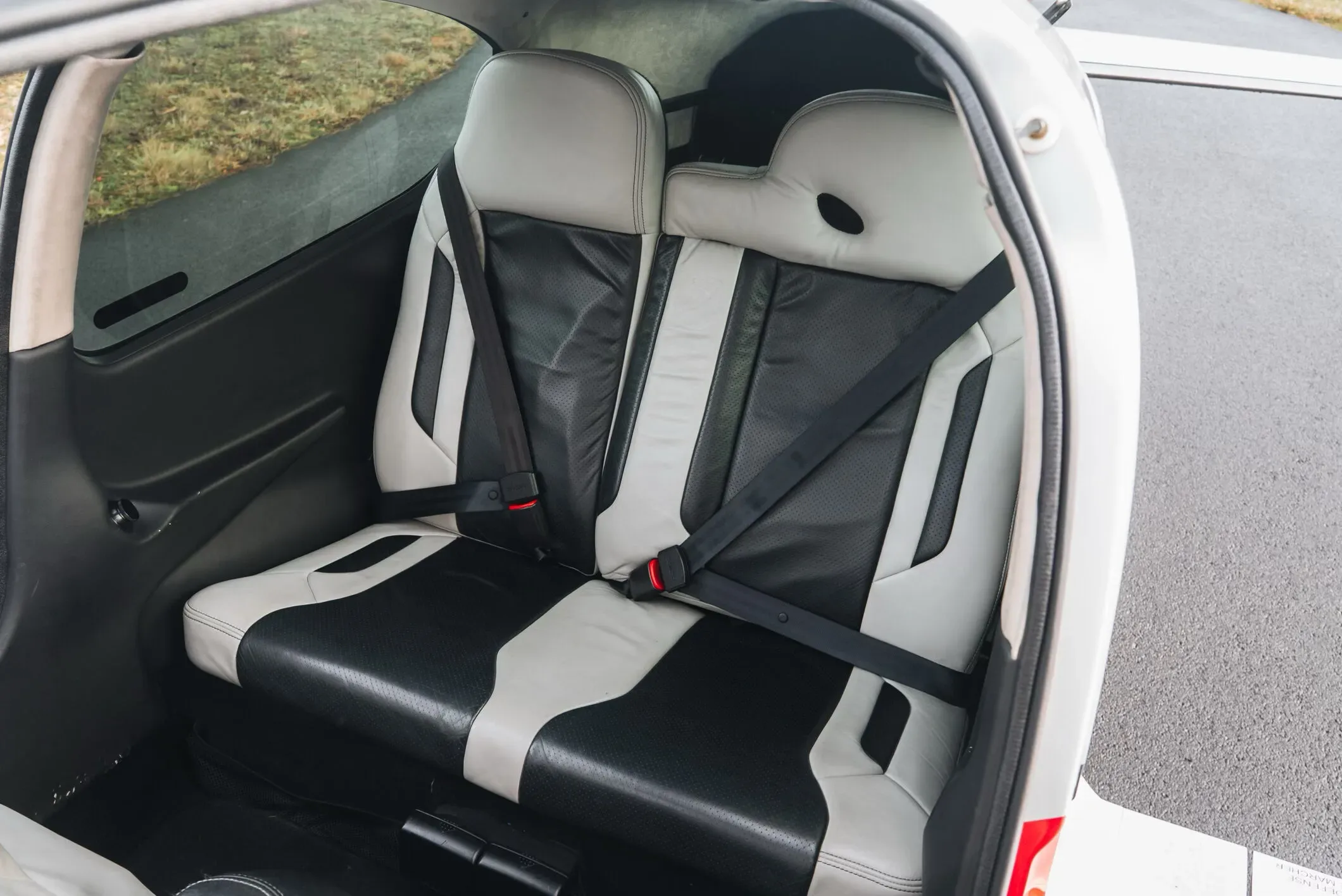 The black and white leather rear seats of a Cirrus SR22 aircraft.
