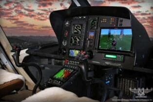 The helicopter's cockpit features modern avionics and displays.