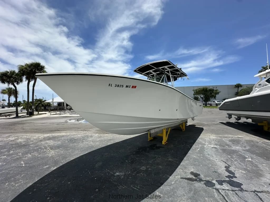 Front side view of the white boat on a trailer.
