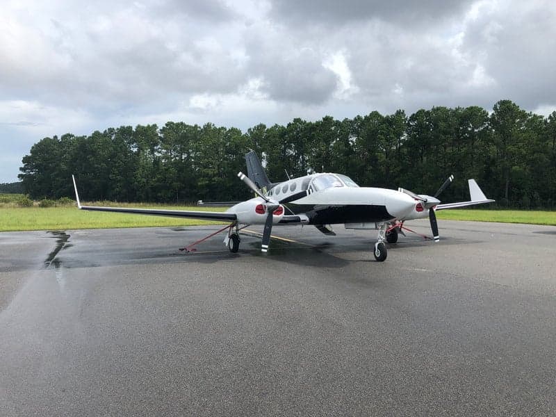 The N513JN aircraft is parked on the tarmac with a black and white paint scheme.