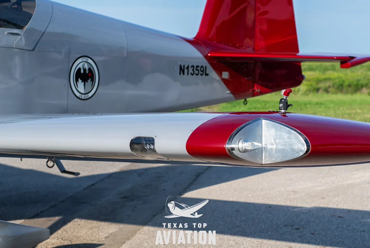 A close-up of the right wingtip and rear fuselage of N1359L, showing the tail number and a circular emblem.