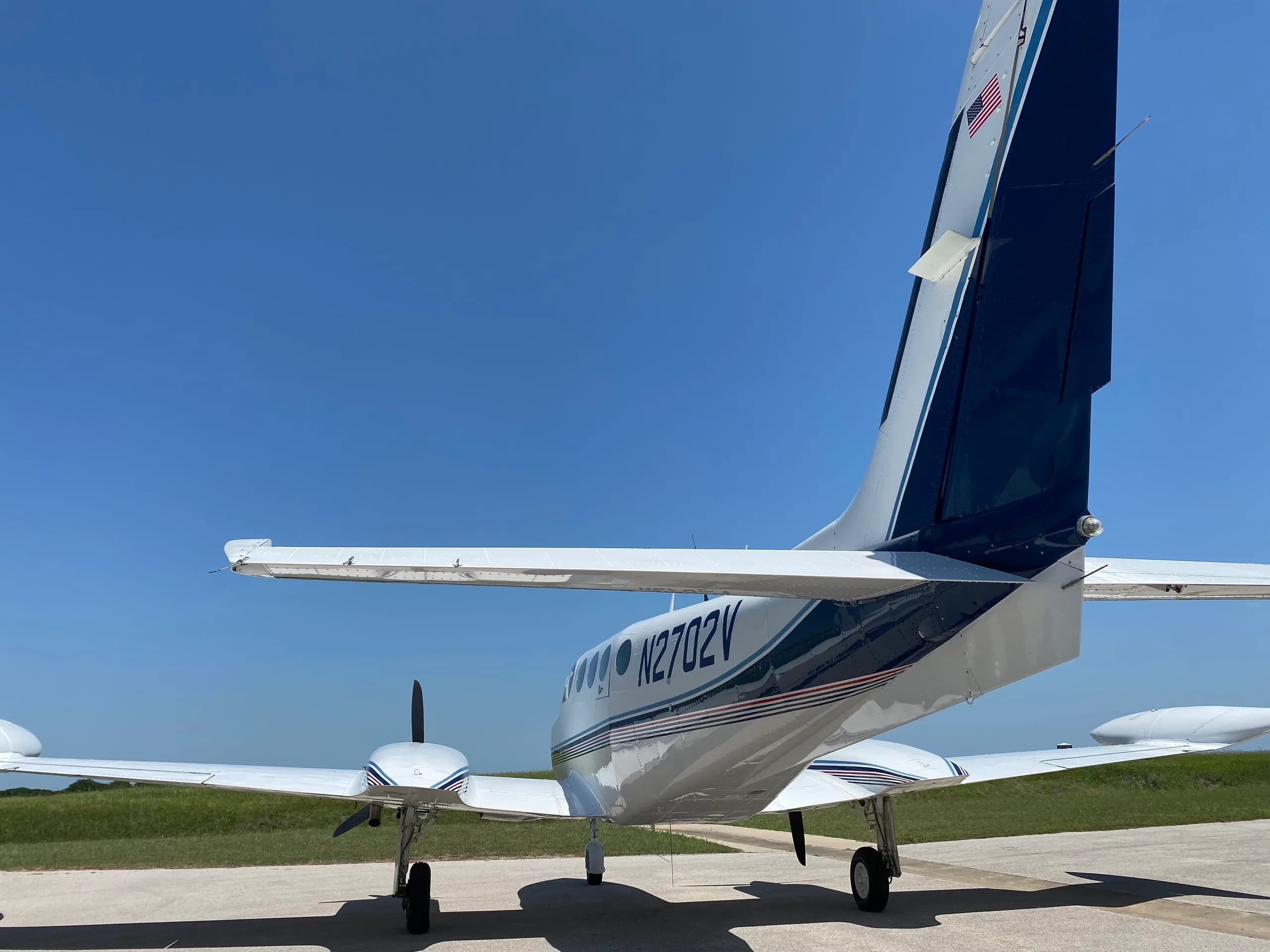 Close-up of the tail and registration N2702V of a Cessna 340A aircraft.
