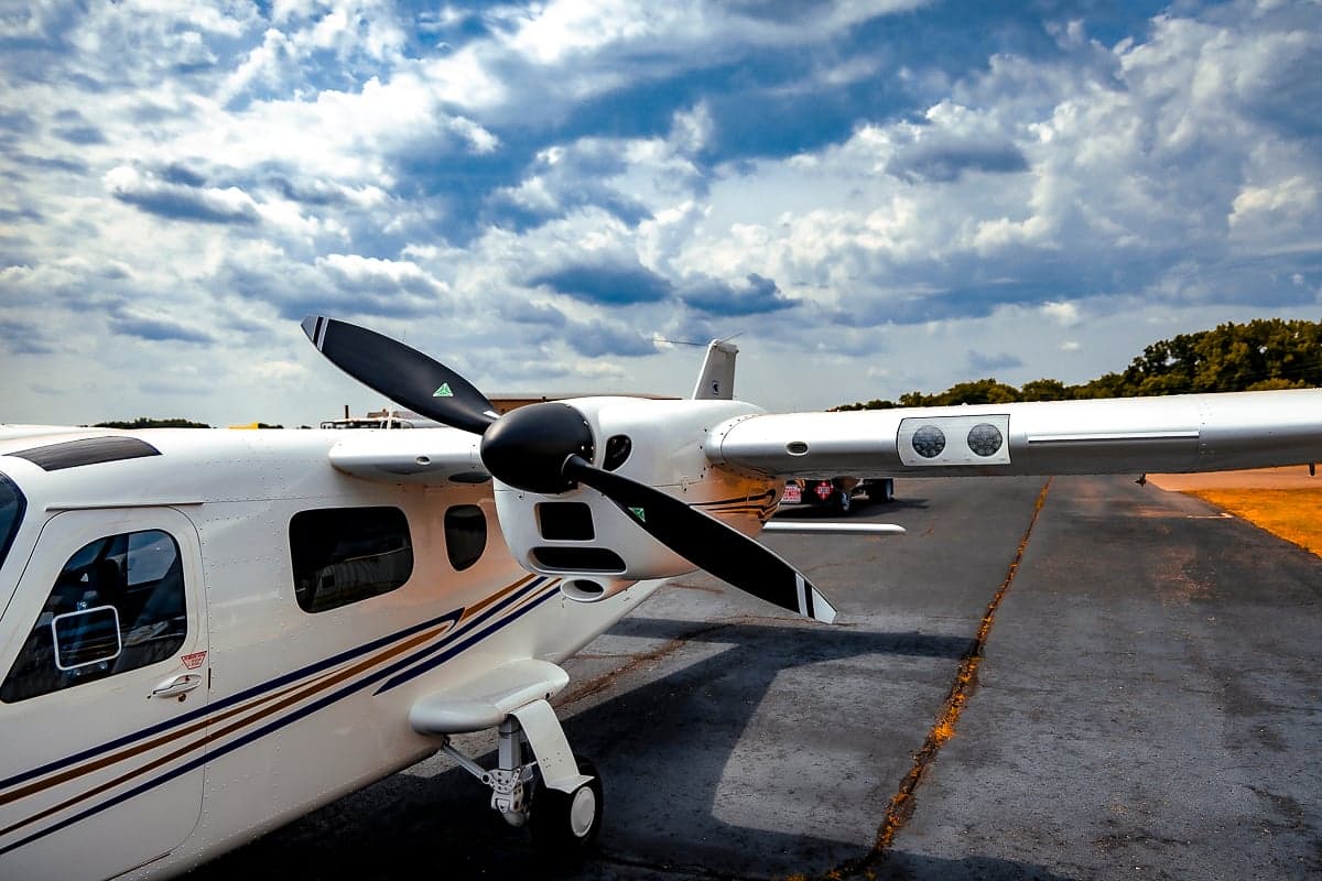 Close-up of the propeller and nose of a Tecnam P2006T aircraft on the tarmac.