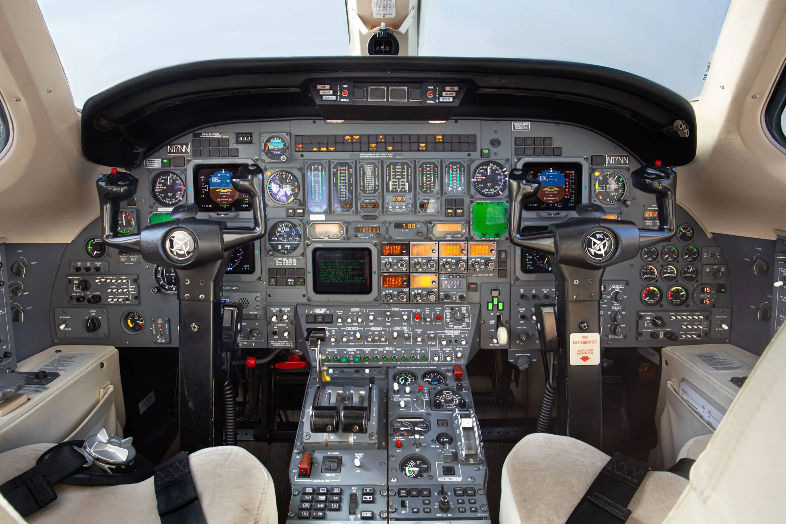 The detailed instrument panel and controls of a Cessna Citation III cockpit, featuring multiple gauges and screens.