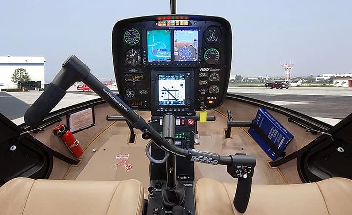 The instrument panel of a Robinson R66 Turbine helicopter with tan interior.