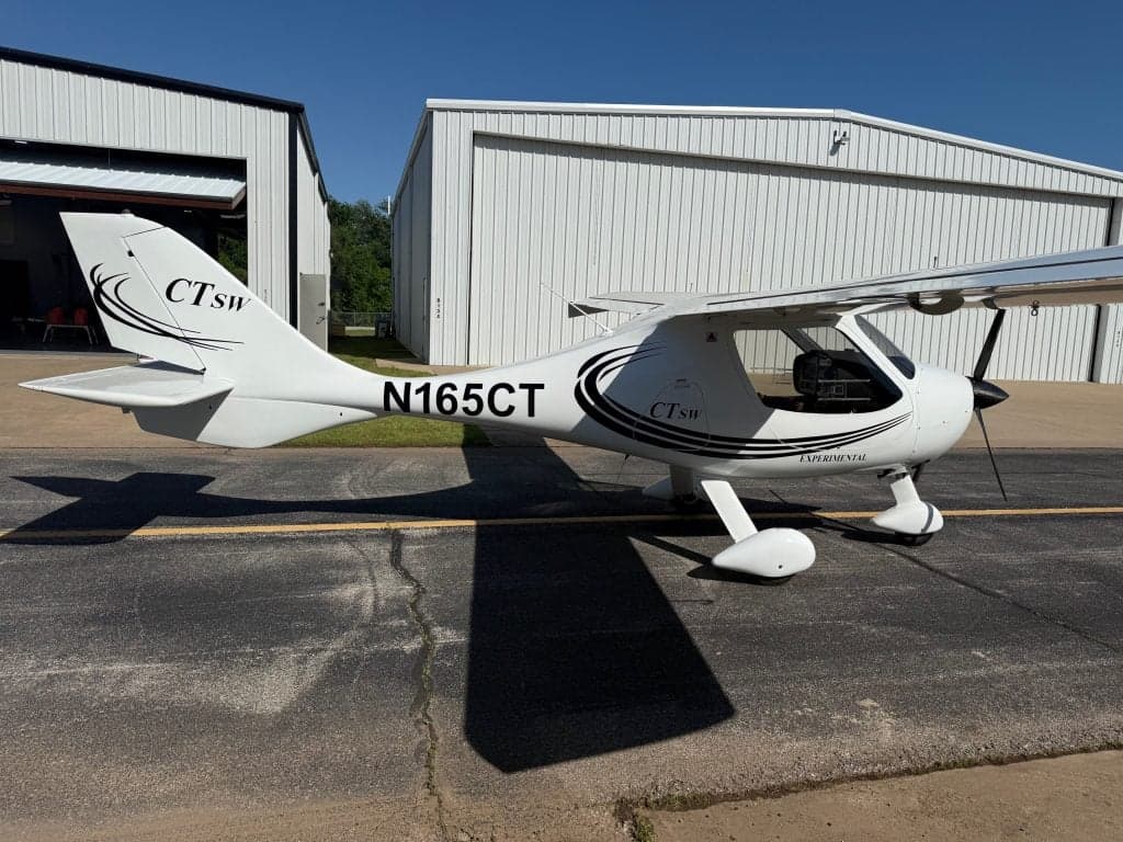 The CTLSW aircraft N165CT is parked on the tarmac in front of a hangar.