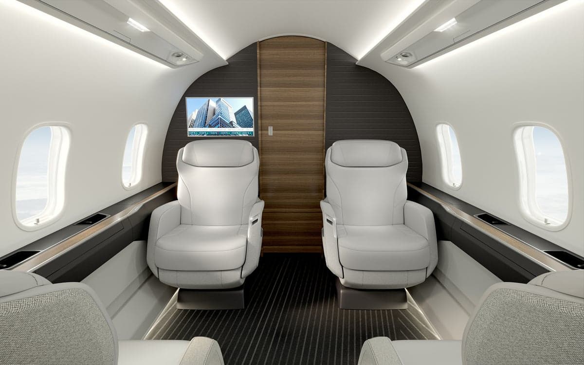 A view of the Challenger 3500 cabin with white leather seats.