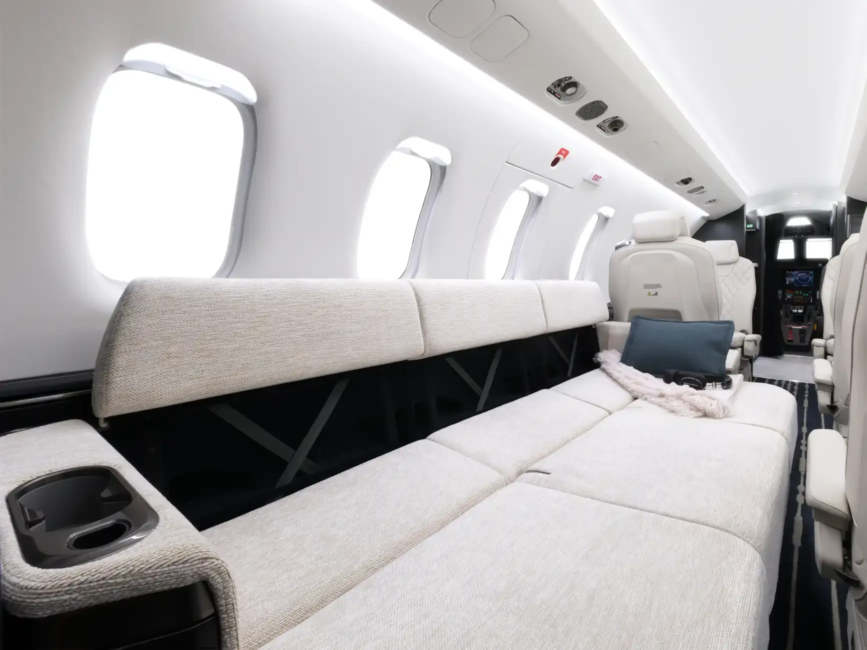 View of the aircraft interior with a couch and seating area.