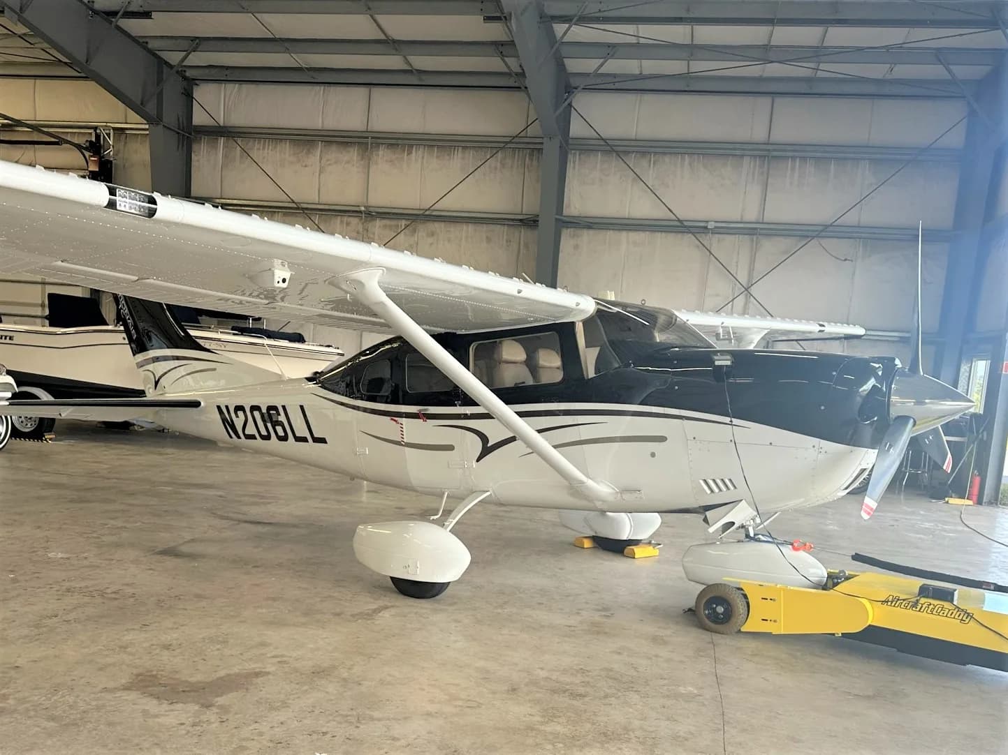Cessna 206 Stationair aircraft N206LL parked in a hangar.
