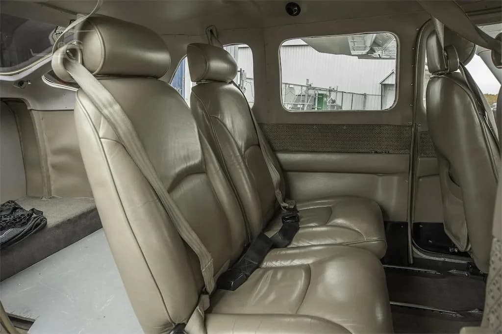 A close-up view of the tan leather rear seats inside the aircraft cabin.