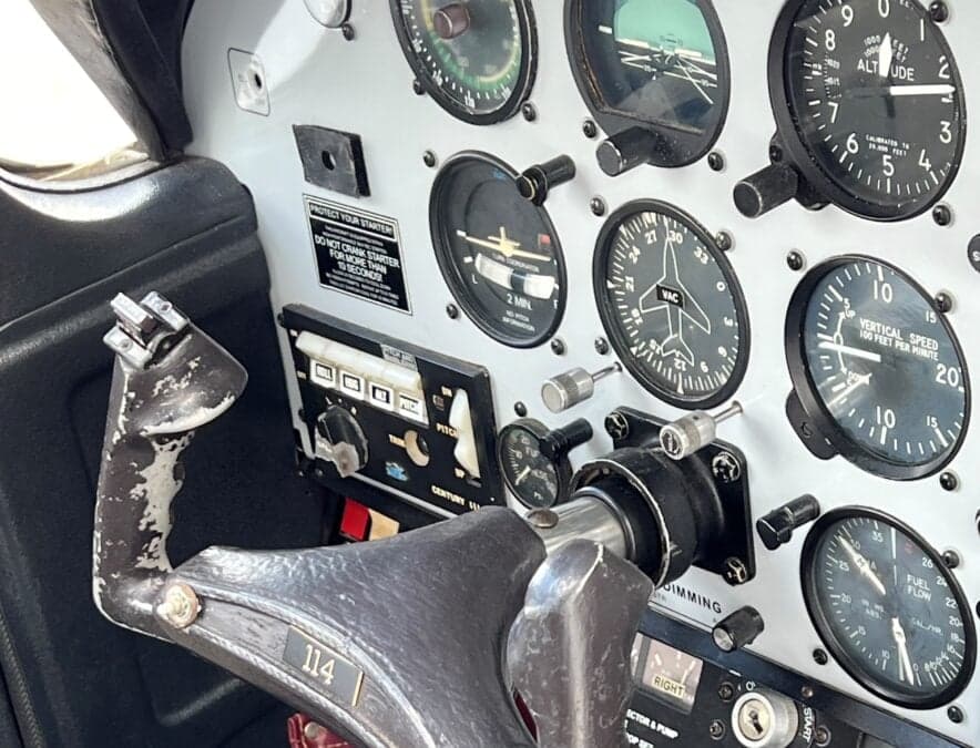 Close-up of the instrument panel and control yoke in the cockpit.