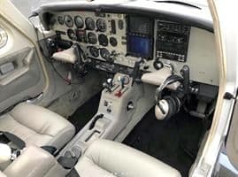 View of the aircraft cockpit with instrument panel and seats.