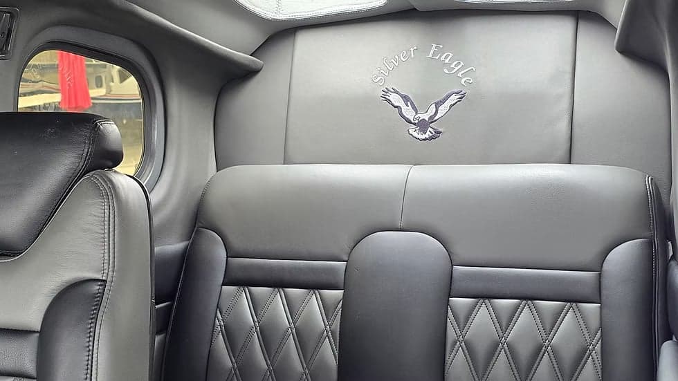 Rear passenger seats in the Cessna Caravan, featuring a 'Silver Eagle' logo embroidered on the headrest.