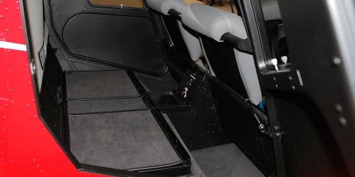 Robinson helicopter cargo compartment with toolbox and hardhat.
