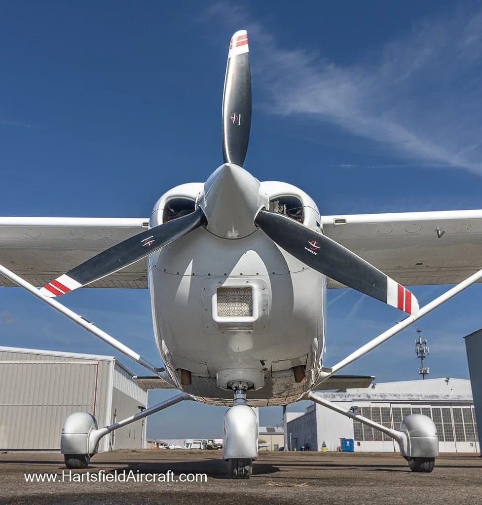Front view of a Cessna Skylane aircraft with a white and gray paint scheme.