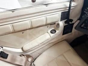 Close-up of the aircraft's interior door panel and seat with cream-colored upholstery.