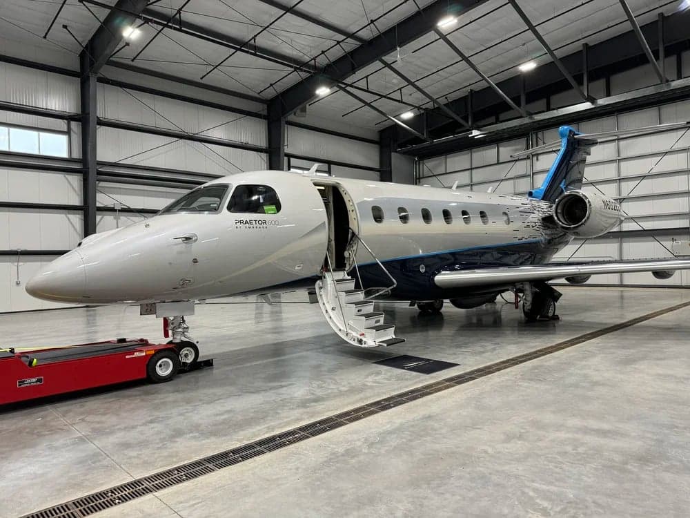 N602EE Praetor 600 aircraft in a hangar with the entry stairs down.