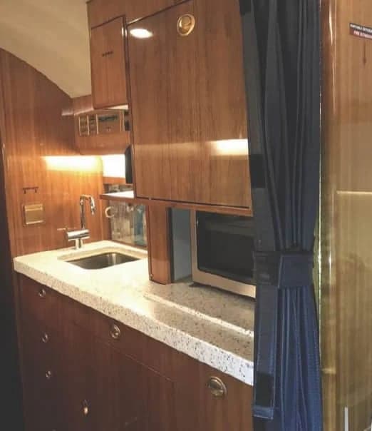 Interior view of the aircraft's galley area with a sink and microwave.