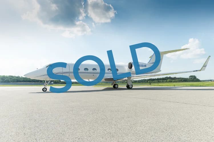 A white Gulfstream business jet, tail number N600AR, is parked on an airport tarmac under a partly cloudy sky.