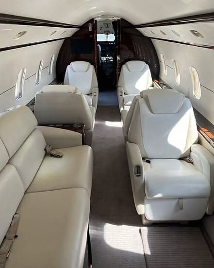 View of the aircraft interior showing the seating arrangement and cockpit.