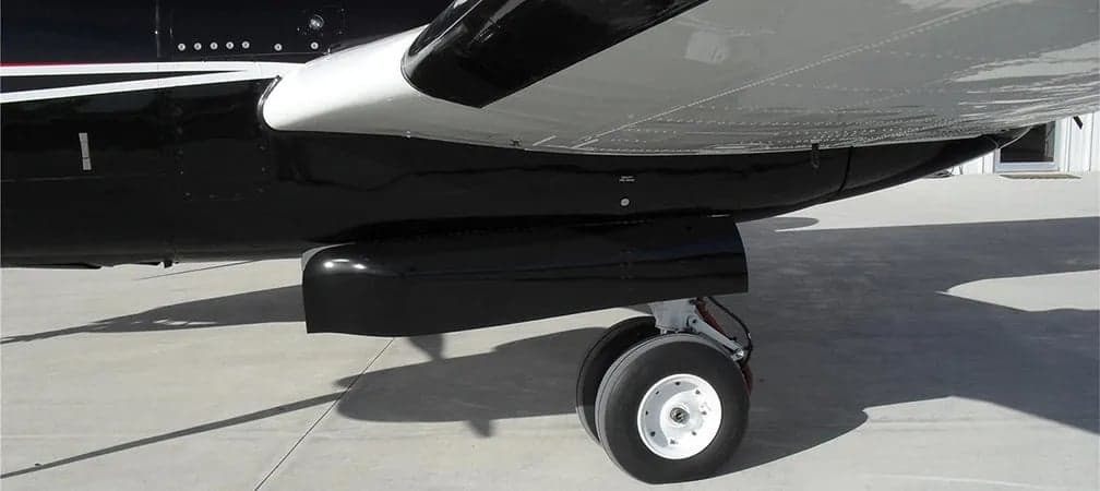 Close-up of the landing gear and underside of a King Air aircraft.