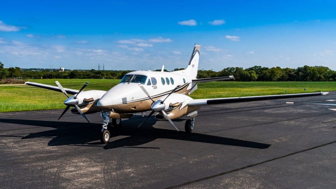 A King Air C90GTi aircraft with registration N920TT is parked on the tarmac.