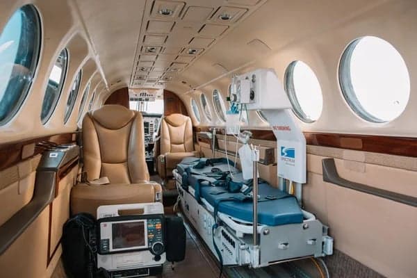 Interior view of the King Air aircraft configured for medical transport, with a stretcher and medical equipment.