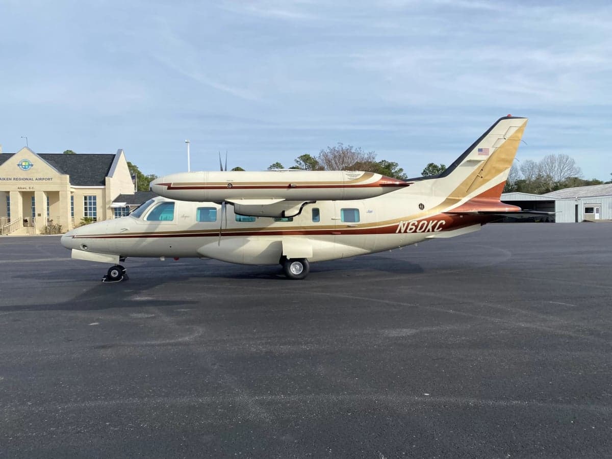 Side view of the Mitsubishi MU-300 Diamond aircraft with tail number N60KC on the tarmac at Aiken Regional Airport.