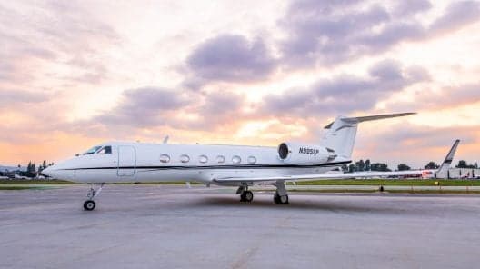 Bombardier Challenger 350 on the tarmac with a white paint scheme and blue accent stripe.