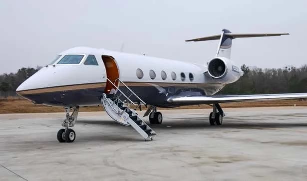 Gulfstream jet on the tarmac with airstair deployed.