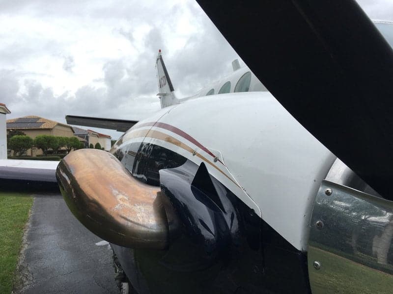 A detailed shot of the Beechcraft King Air 90C's engine exhaust and propeller, highlighting the aircraft's design.