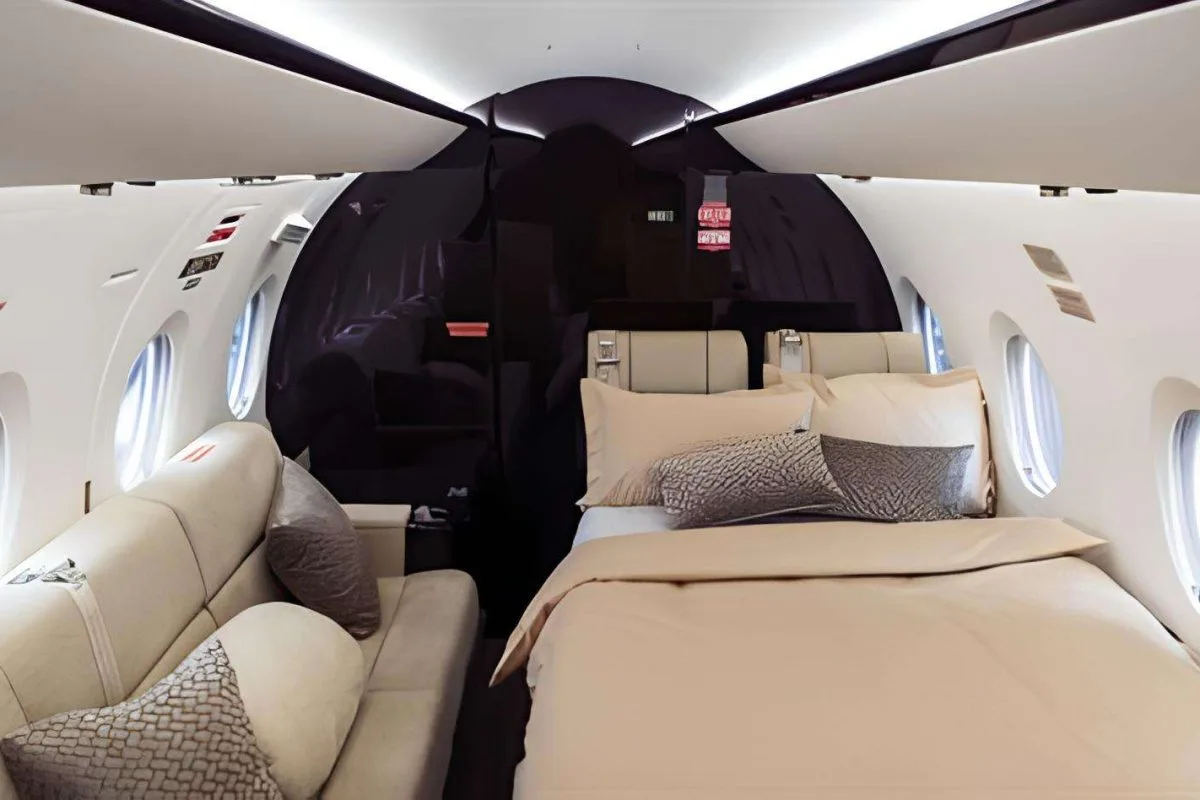A view of the aircraft cabin with a bed and a couch.