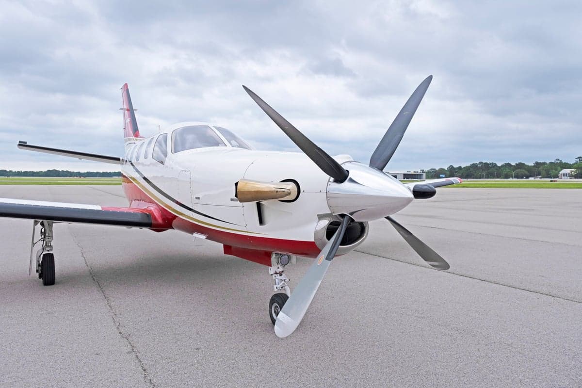 Close up front view of the TBM 850 aircraft N836EA on the tarmac.