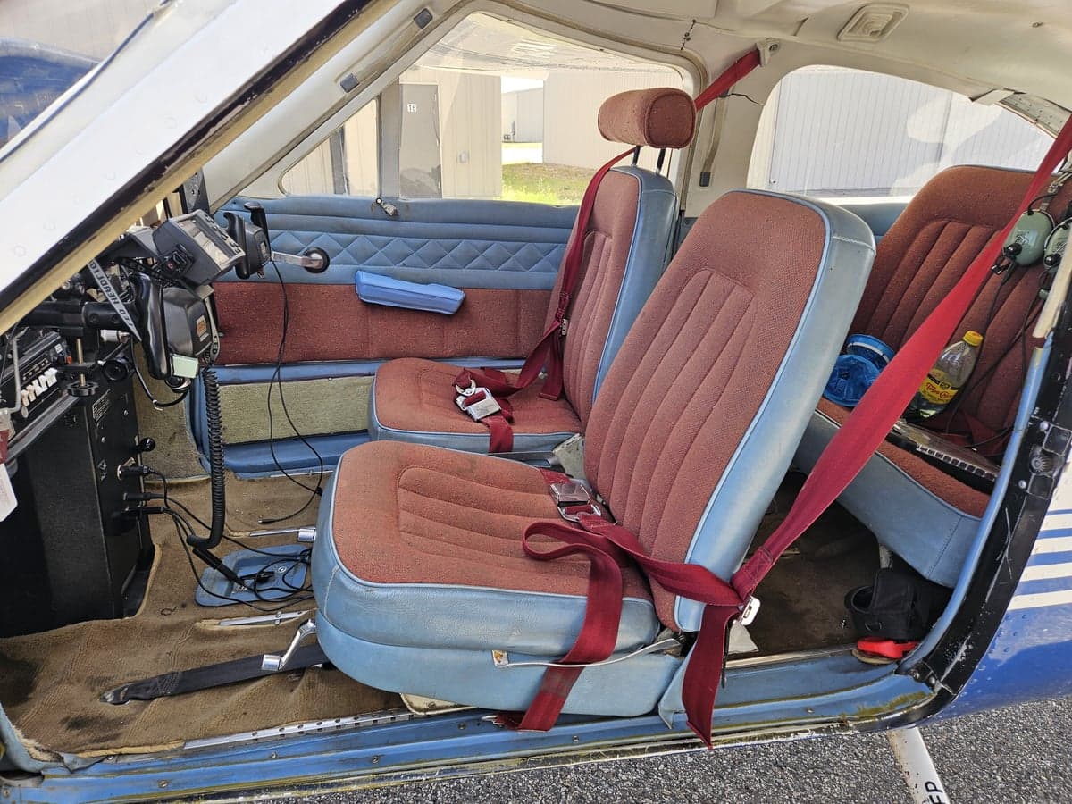 The interior of a Cessna 182 Skylane, showing the seats and side panel.