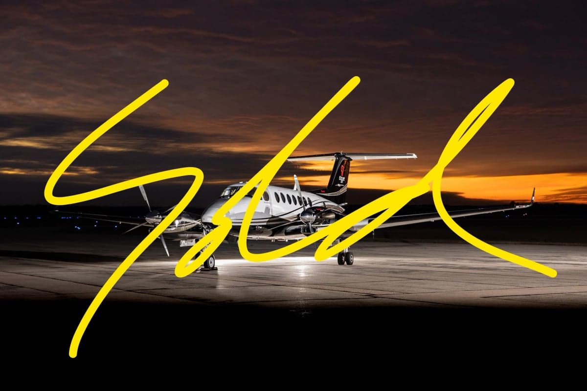 A King Air 350i aircraft is parked on the tarmac at dusk, with a 'SOLD' overlay.