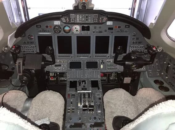 View of the aircraft cockpit with instrument panel and controls.
