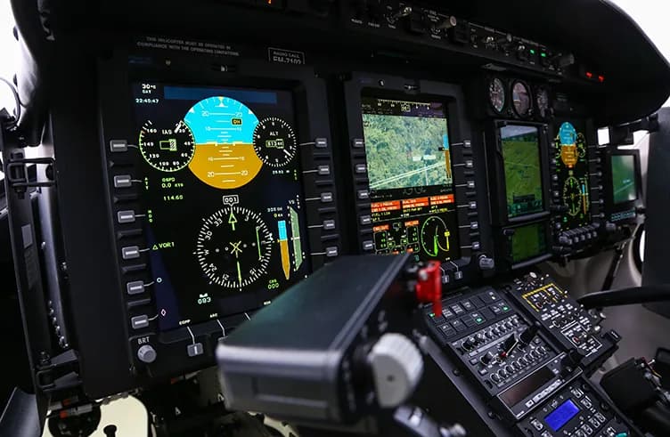 A close-up of a helicopter's digital instrument panel.