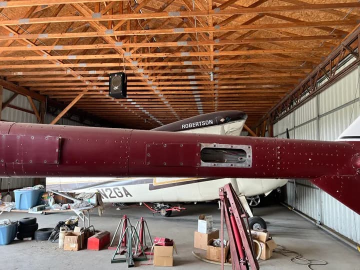 Close-up of the tail section of an aircraft inside a hangar.