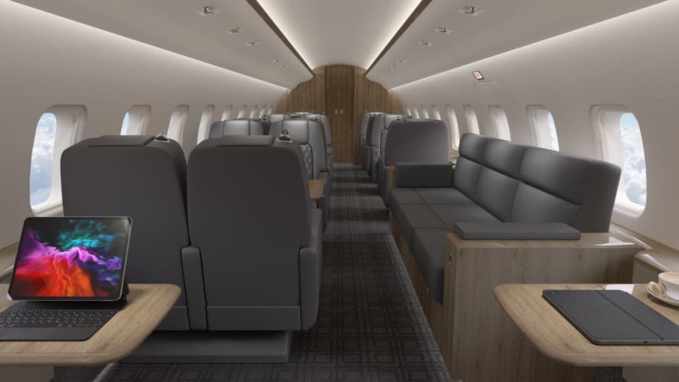 A modern aircraft interior with gray seats and wood accents.