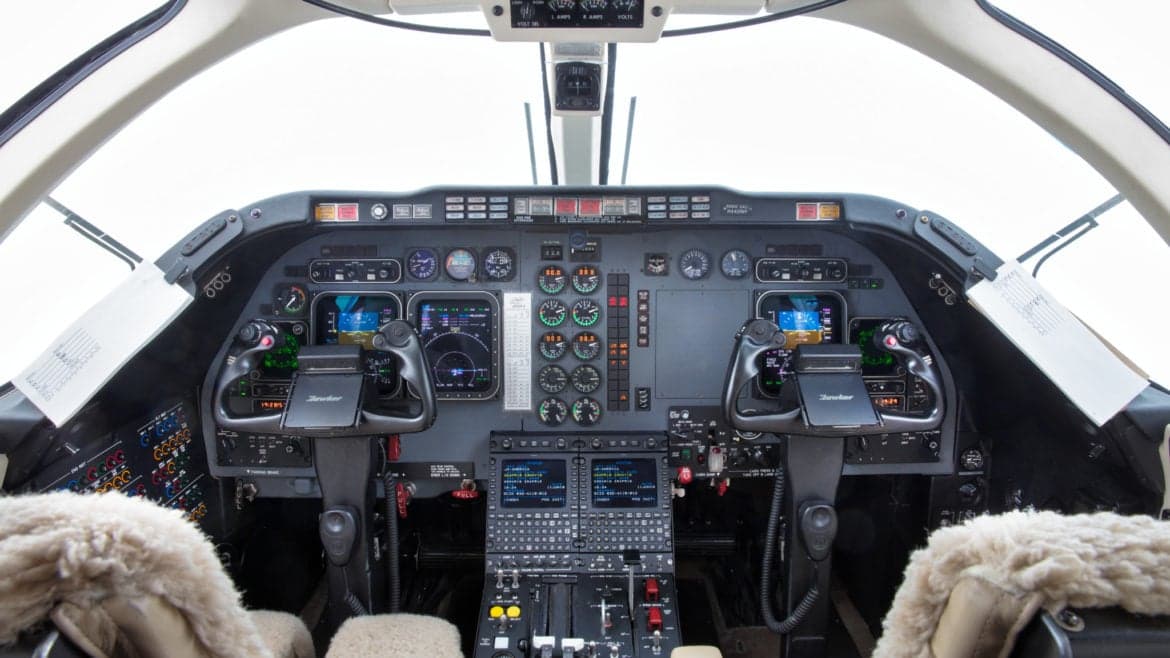 View of the aircraft's cockpit, showing the instrument panel and controls.