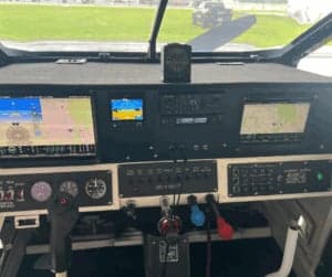 The aircraft's cockpit features a modern instrument panel with multiple screens and controls.