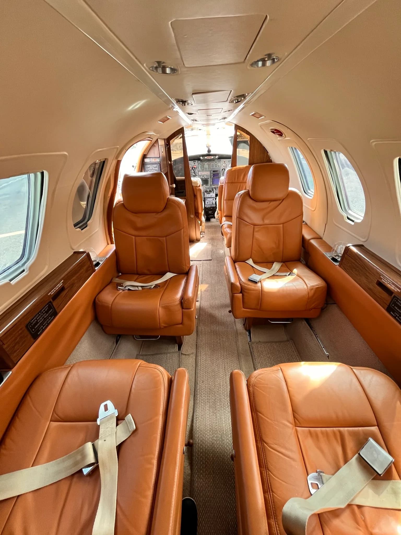 Forward view of the Cessna Citation Mustang cabin with tan leather seats.