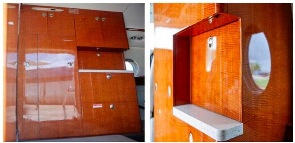 Interior view of the aircraft showing wooden cabinetry and storage compartments.