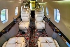 Close up of a cream-colored leather seat in the cabin of a Cessna Citation CJ3+.